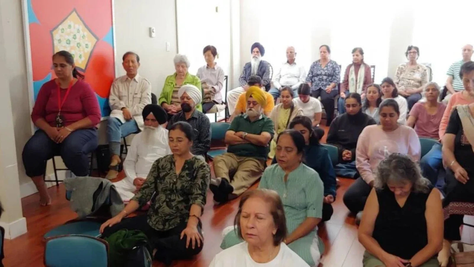 A group seated together in a meditation session
